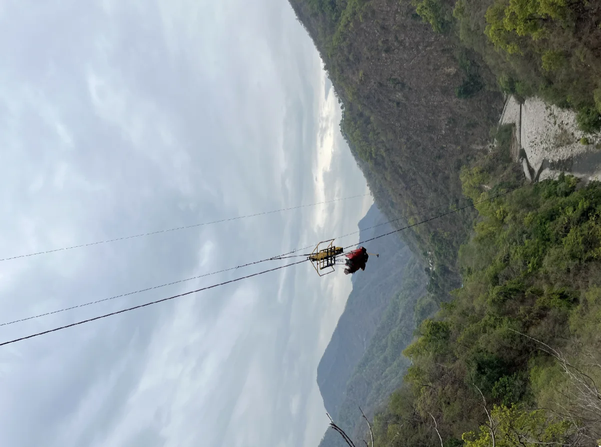 Person doing Flying Fox in Rishikesh over Ganga river with mountains view, thrilling zipline experience at best price 2026 by bucketlistt